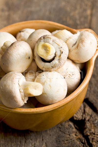 Champignon mushrooms in ceramic bowl. Stock photo © jirkaejc