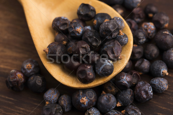 Juniper berries on a wooden background Stock photo © joannawnuk