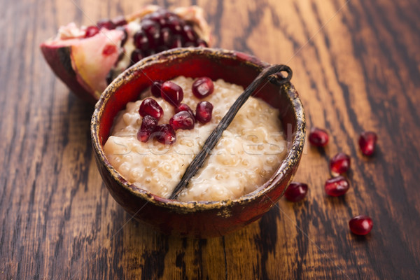 A bowl of tapioca pudding with vanilla and pomegranate Stock photo © joannawnuk