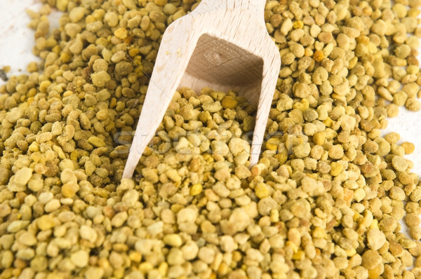 Stock photo: Bee pollen in wooden scoop. Nutritional supplement