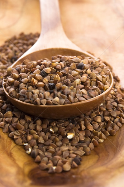 Buckwheat seeds on wooden spoon in closeup  Stock photo © joannawnuk