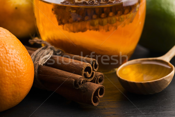 honey with citrus fruit and cinnamon Stock photo © joannawnuk