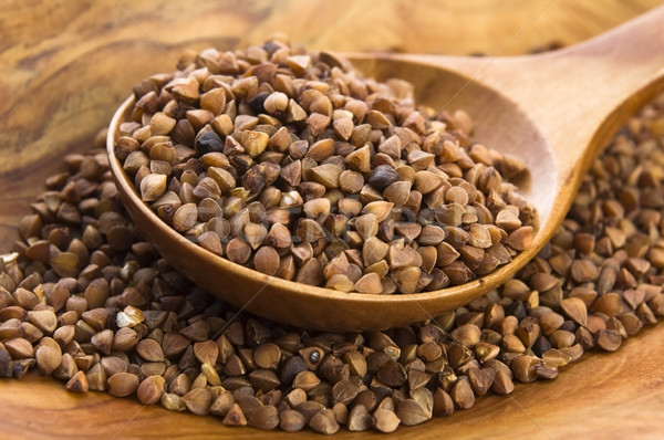 Buckwheat seeds on wooden spoon in closeup  Stock photo © joannawnuk