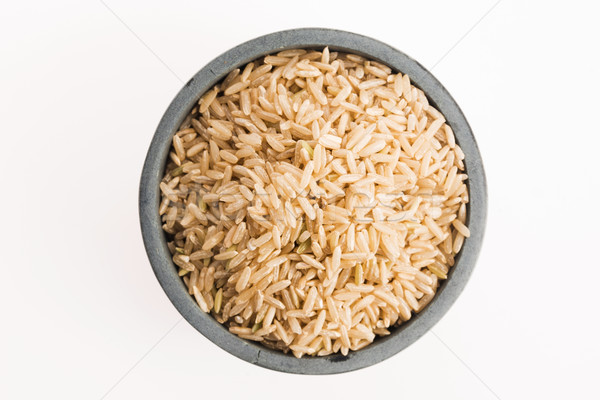 brown rice in a bowl isolated on white background Stock photo © joannawnuk