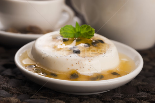 Panna cotta dessert with passion fruit and mint Stock photo © joannawnuk