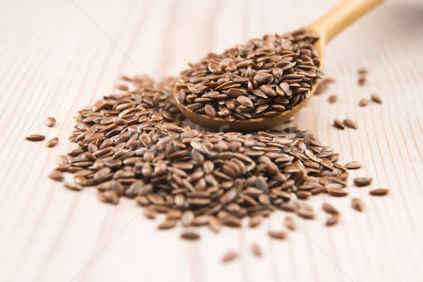 Wooden spoon with flax seed Stock photo © joannawnuk