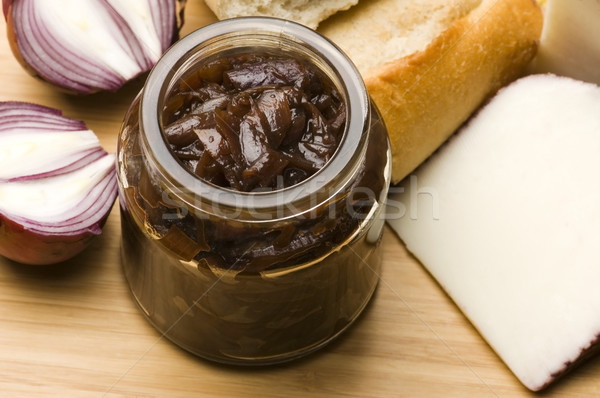 Onion jam in jar, goat's cheese and fresh bread Stock photo © joannawnuk