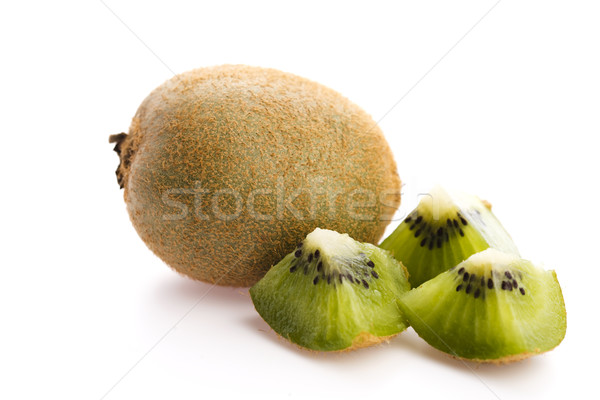 Whole kiwi fruit and his sliced segments isolated on white backg Stock photo © joannawnuk