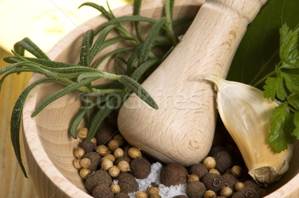 Mortar with fresh herbs and allspice berries Stock photo © joannawnuk