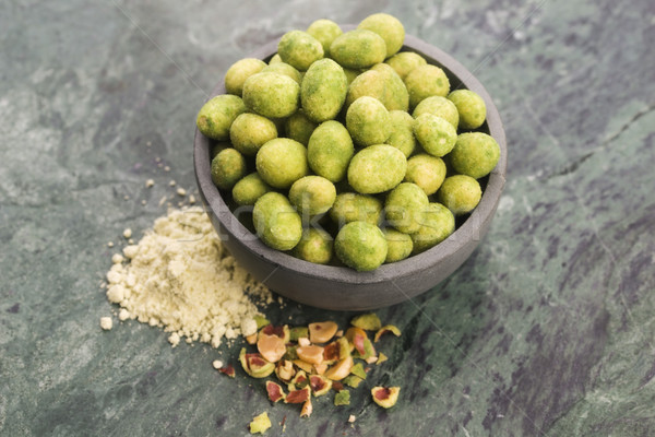 Stock photo: Pile of wasabi coated peanuts in bowl