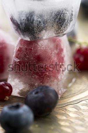 Fresh berry fruits frozen in ice cubes Stock photo © joannawnuk