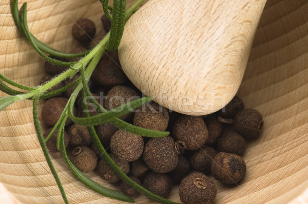 Mortar with fresh herbs and allspice berries Stock photo © joannawnuk