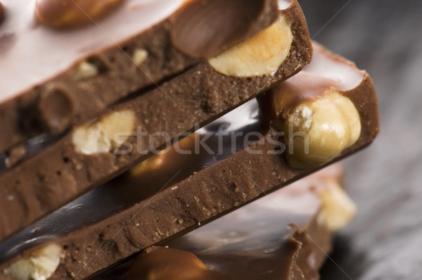 Pile of broken chocolate with nuts Stock photo © joannawnuk