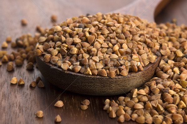 Buckwheat seeds on wooden spoon in closeup  Stock photo © joannawnuk