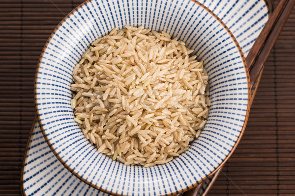 Raw brown rice in a bowl Stock photo © joannawnuk