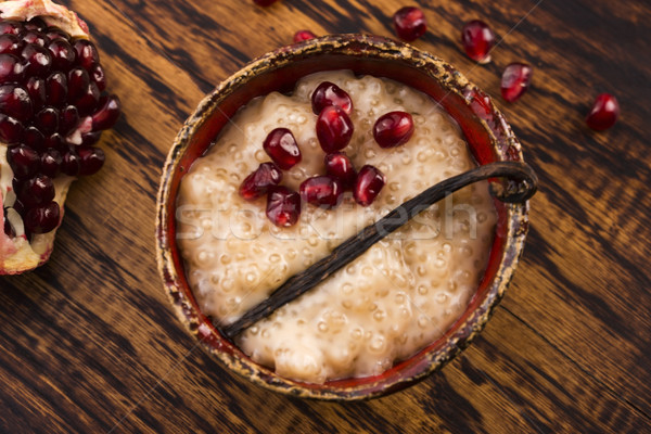 A bowl of tapioca pudding with vanilla and pomegranate Stock photo © joannawnuk