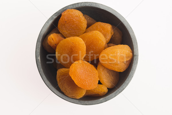 Delicious dried apricots in a bowl Stock photo © joannawnuk