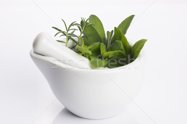 mortar with herbs isolated on a white background Stock photo © joannawnuk