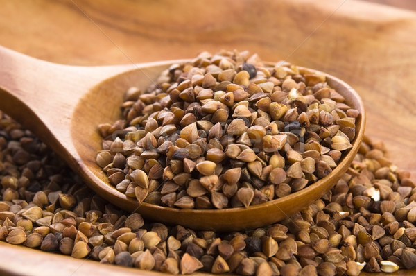 Buckwheat seeds on wooden spoon in closeup  Stock photo © joannawnuk