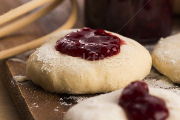 Dough with marmelade on wooden board Stock photo © joannawnuk
