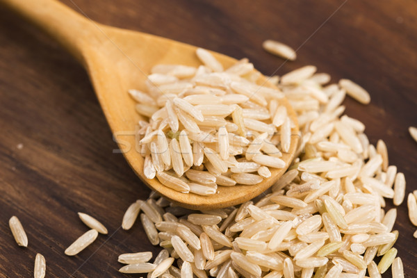 Spoon of brown rice close up Stock photo © joannawnuk