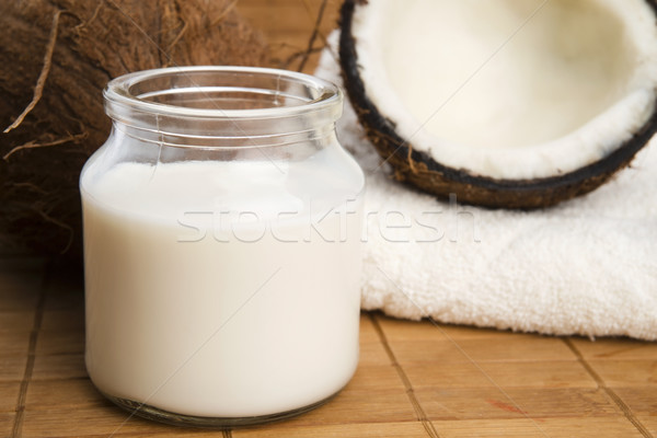 coconut fruit with a jar filled with coco milk Stock photo © joannawnuk