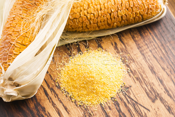 Corn groats and seeds, corncobs on wooden rustic table Stock photo © joannawnuk