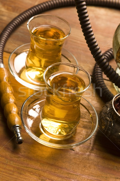 Stock photo: Cup of turkish tea and hookah served in traditional style
