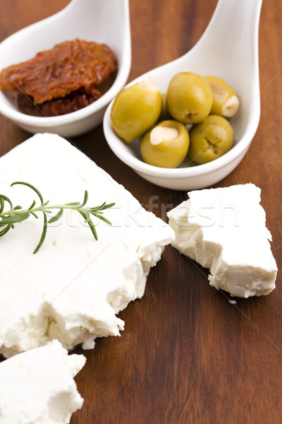 Feta cheese with olives, sun dried tomatoes and fresh herbs Stock photo © joannawnuk