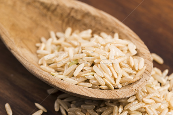 Spoon of brown rice close up Stock photo © joannawnuk