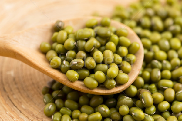 Mung beans over wooden spoon Stock photo © joannawnuk