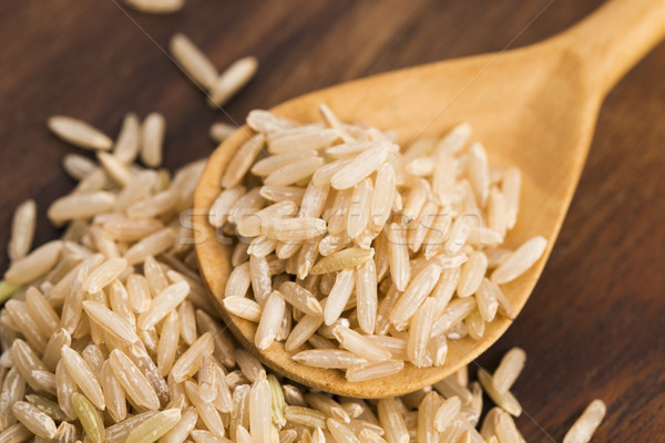 Spoon of brown rice close up Stock photo © joannawnuk