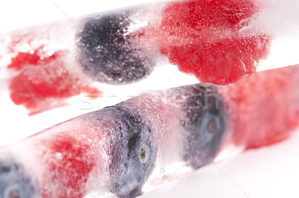 Raspberry and blackberry frozen in ice sticks Stock photo © joannawnuk