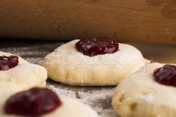 Dough with marmelade on wooden board Stock photo © joannawnuk