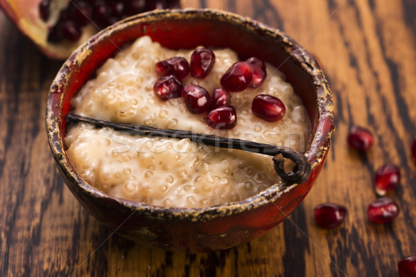 A bowl of tapioca pudding with vanilla and pomegranate Stock photo © joannawnuk