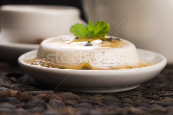 Panna cotta dessert with passion fruit and mint Stock photo © joannawnuk