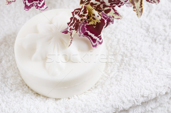 Spa items with white towels, natural soap and orchid Stock photo © joannawnuk