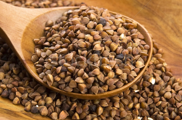 Buckwheat seeds on wooden spoon in closeup  Stock photo © joannawnuk