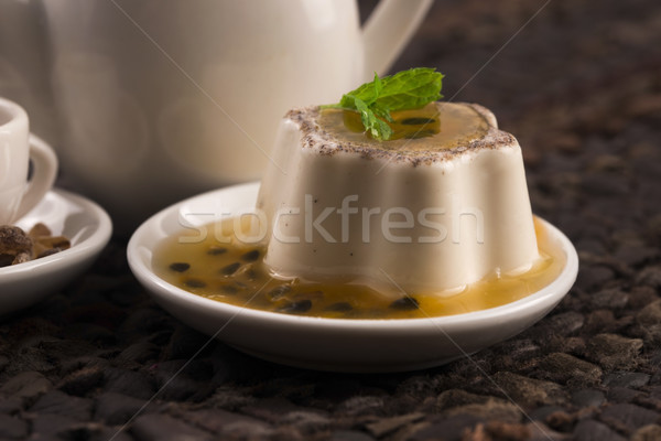 Panna cotta dessert with passion fruit and mint Stock photo © joannawnuk