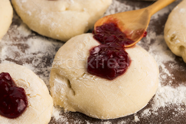 Dough with marmelade on wooden board Stock photo © joannawnuk
