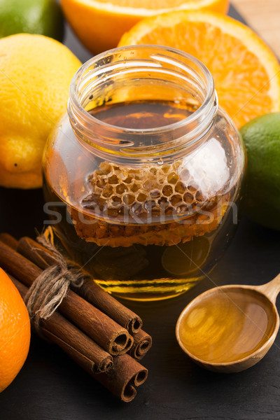 honey with citrus fruit and cinnamon Stock photo © joannawnuk