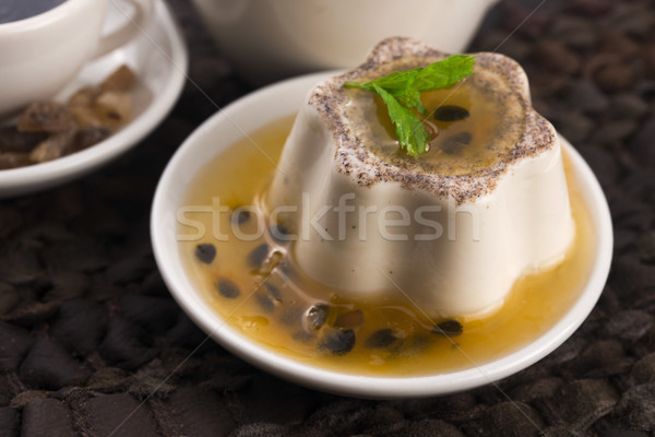 Panna cotta dessert with passion fruit and mint Stock photo © joannawnuk