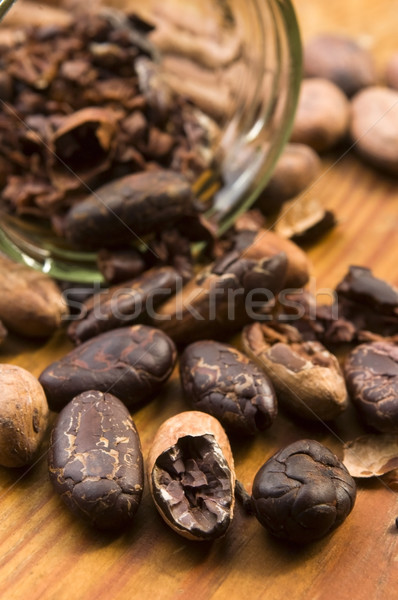 Cocoa (cacao) beans on natural wooden table Stock photo © joannawnuk