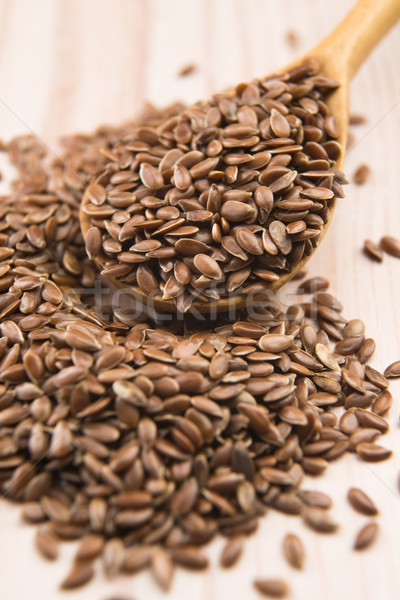 Wooden spoon with flax seed Stock photo © joannawnuk