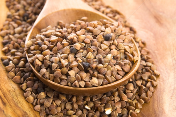 Buckwheat seeds on wooden spoon in closeup  Stock photo © joannawnuk