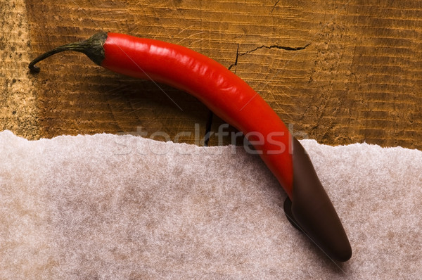 Red hot chilli pepper with dark chocolate Stock photo © joannawnuk