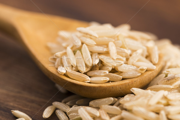 Spoon of brown rice close up Stock photo © joannawnuk