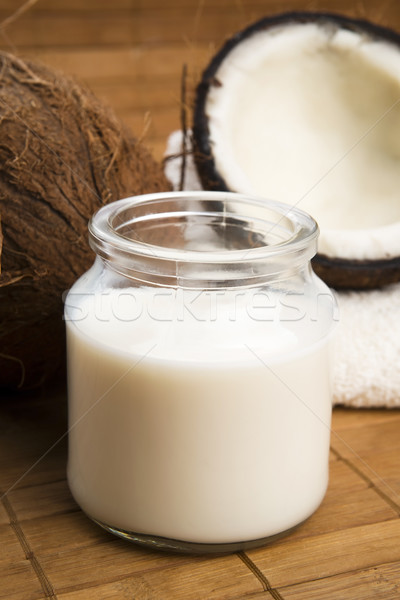 coconut fruit with a jar filled with coco milk Stock photo © joannawnuk