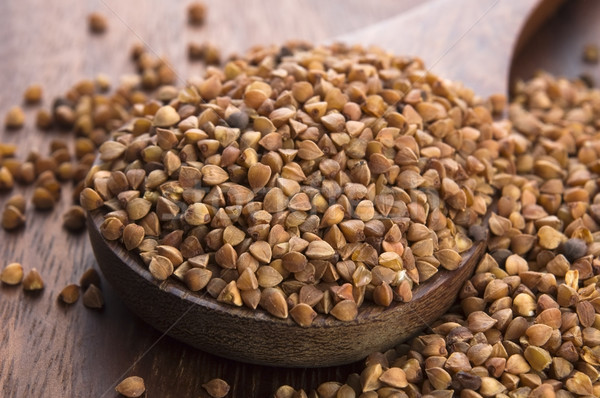 Buckwheat seeds on wooden spoon in closeup  Stock photo © joannawnuk