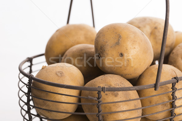 uncooked potatoes in wire basket Stock photo © joannawnuk
